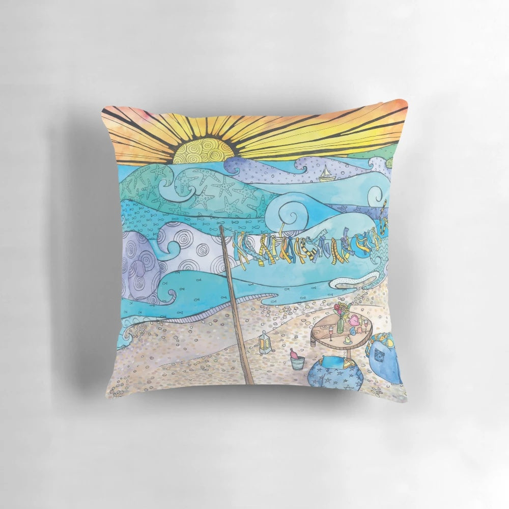 Coastal-inspired decorative pillow featuring an ocean and beach scene