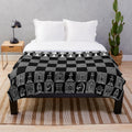 Plush white blanket with chess pattern design, ideal for chess fans and players