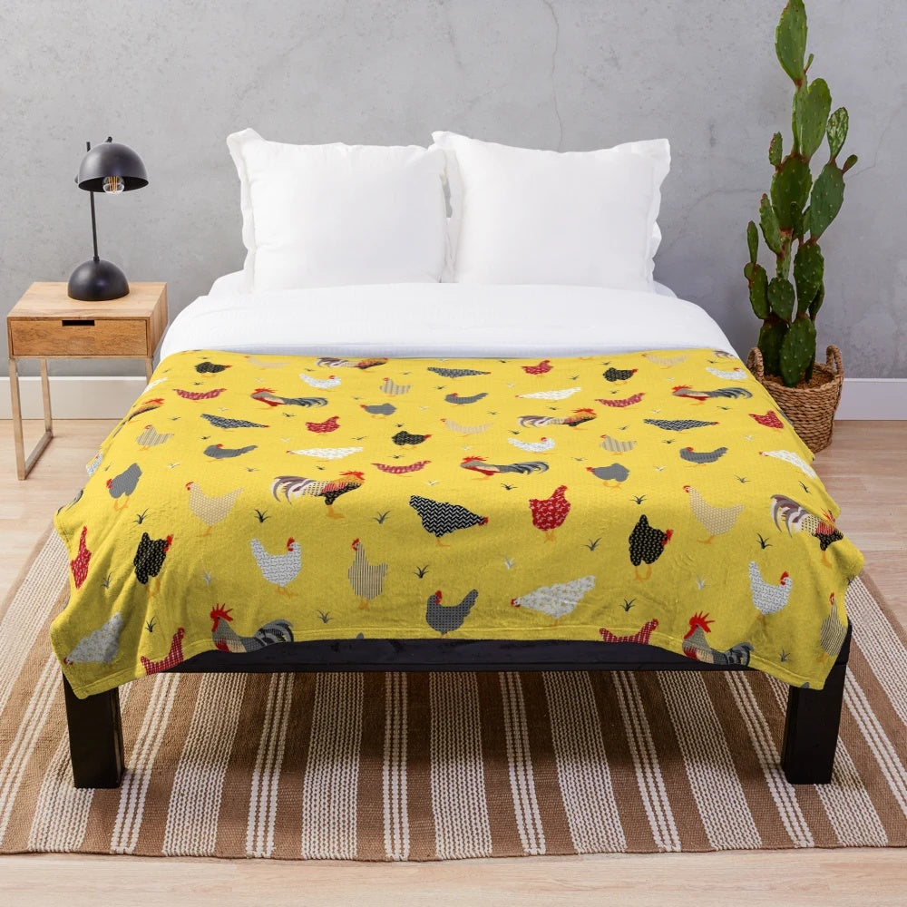 Plush chicken-themed blanket with geometric patterns in yellow and white