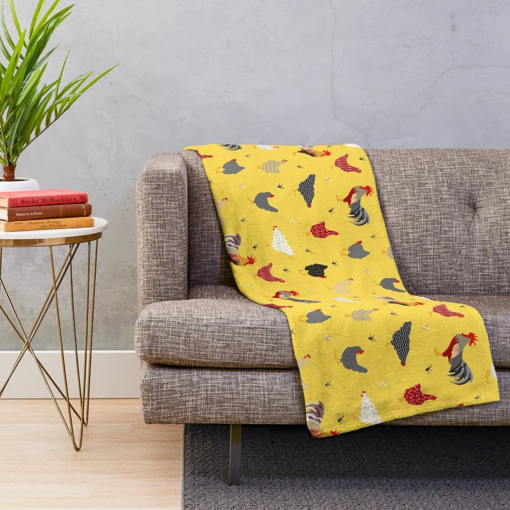 Plush chicken-themed blanket with geometric patterns in yellow and white
