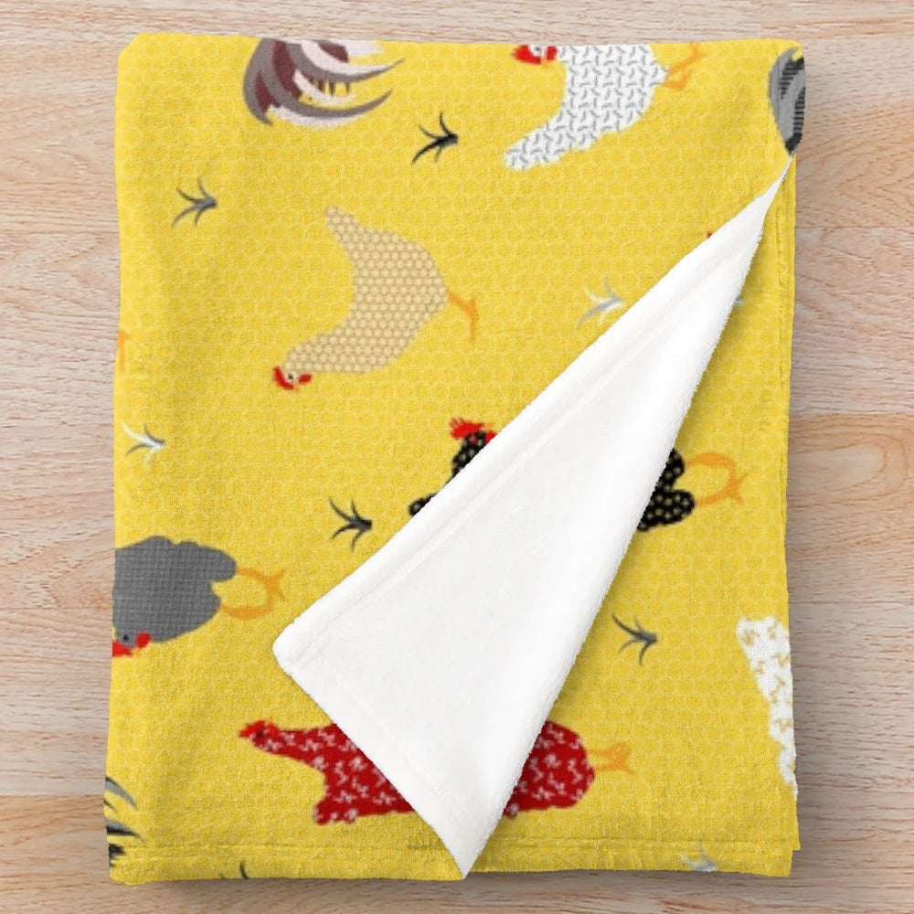 Plush chicken-themed blanket with geometric patterns in yellow and white