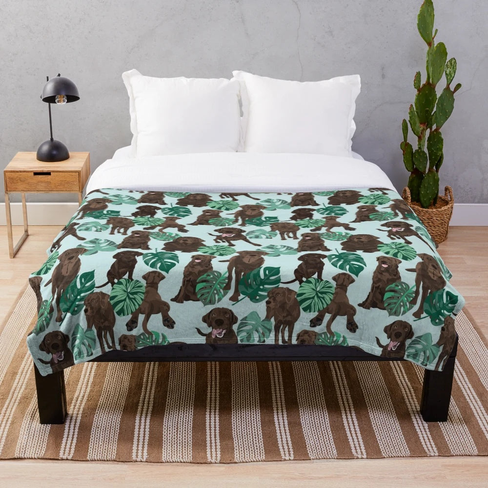 Chocolate Labrador Retriever Curled up on a Tropical Plush Blanket