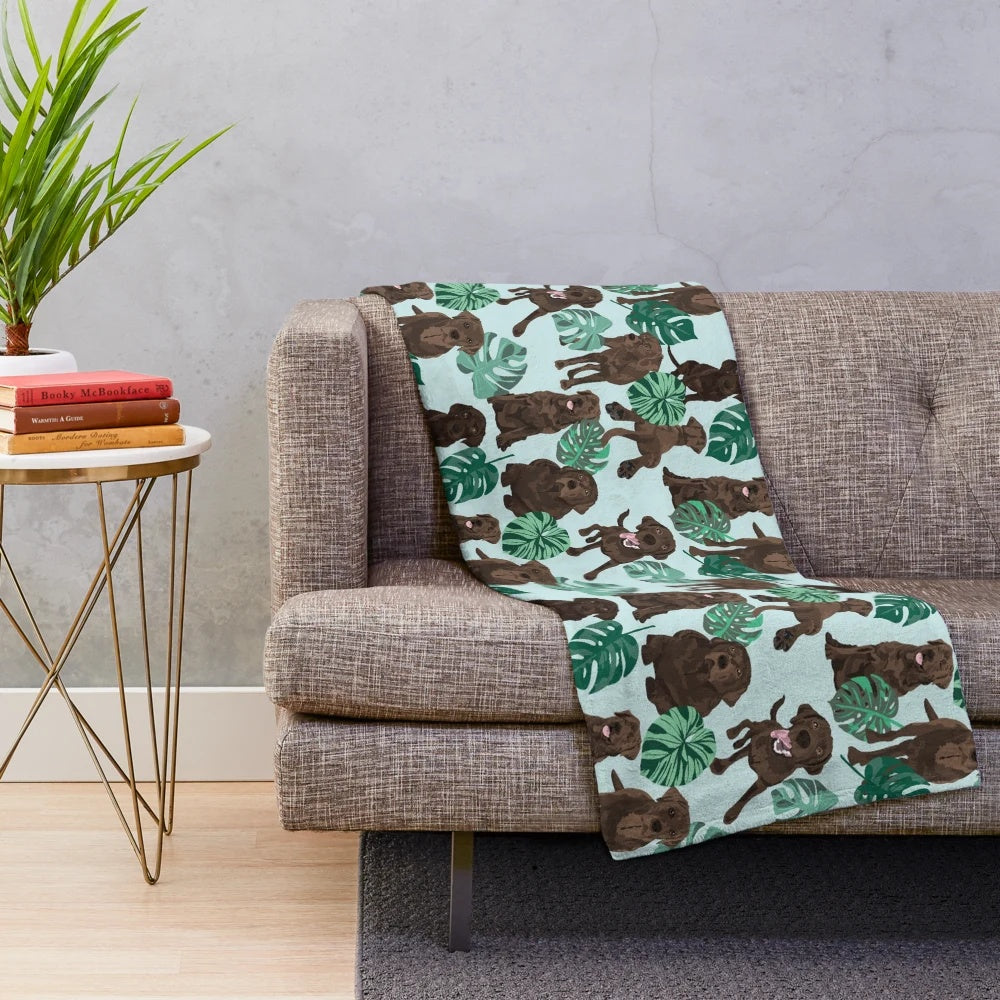 Chocolate Labrador Retriever Curled up on a Tropical Plush Blanket