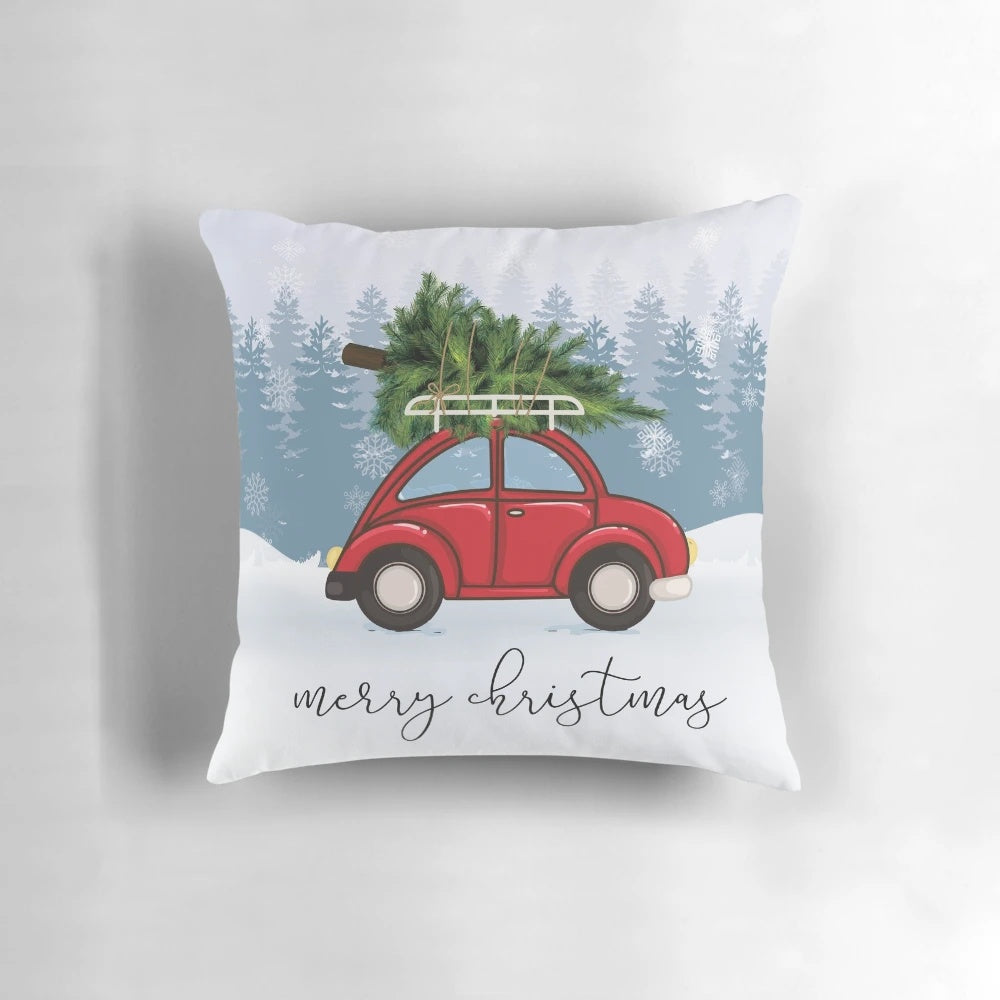 A red car carrying a Christmas tree on its roof, surrounded by snow and Christmas decorations, featured on a plush, personalized pillow.
