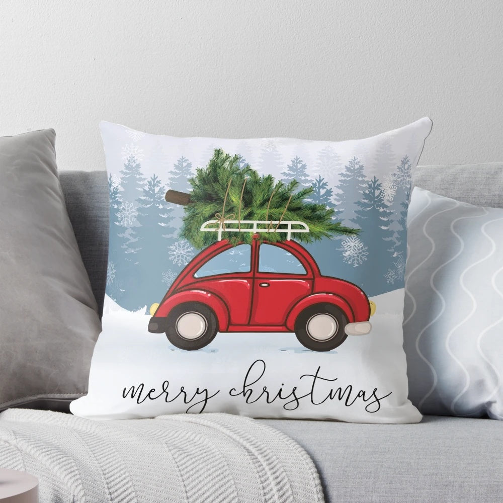 A red car carrying a Christmas tree on its roof, surrounded by snow and Christmas decorations, featured on a plush, personalized pillow.