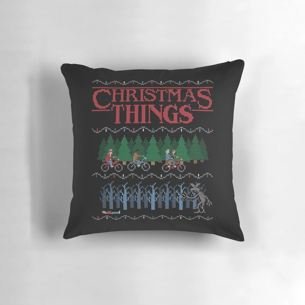 A colorful and festive Christmas pillow featuring an ugly sweater-inspired design.