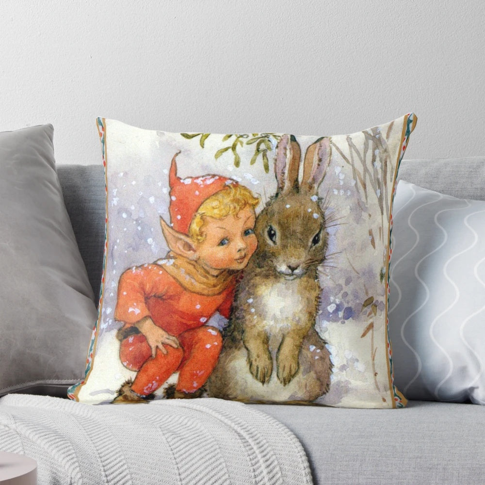 Whimsical Christmas pillow featuring an illustration of an elf and rabbit under mistletoe in a snow-covered woodland scene, designed by artist Margaret Tarrant.