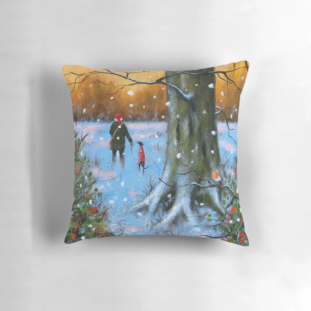 A soft, plush throw pillow featuring a winter landscape with a greyhound and whippet dog silhouettes against a sunset sky.