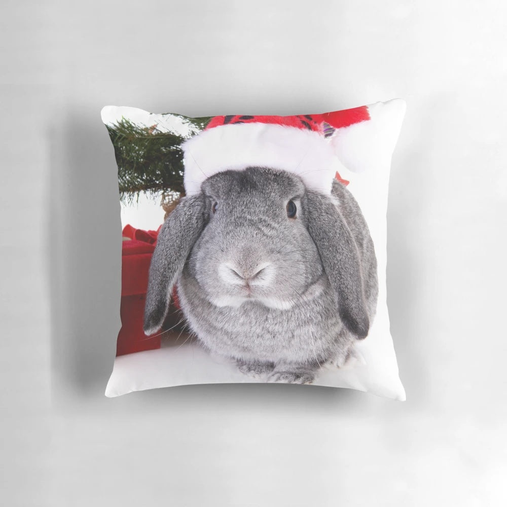 A soft, plush pillow in the shape of a Christmas rabbit, with festive decorations and a warm, fuzzy appearance.