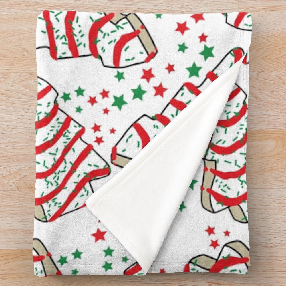 Plush blanket featuring a Christmas tree made of Little Debbie snack cakes