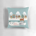 Festive Christmas village scene printed on a soft, plush pillow