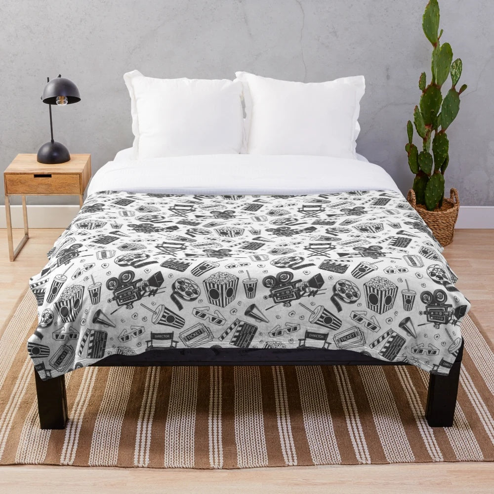 Cinema-themed plush blanket with seamless pattern including movie elements