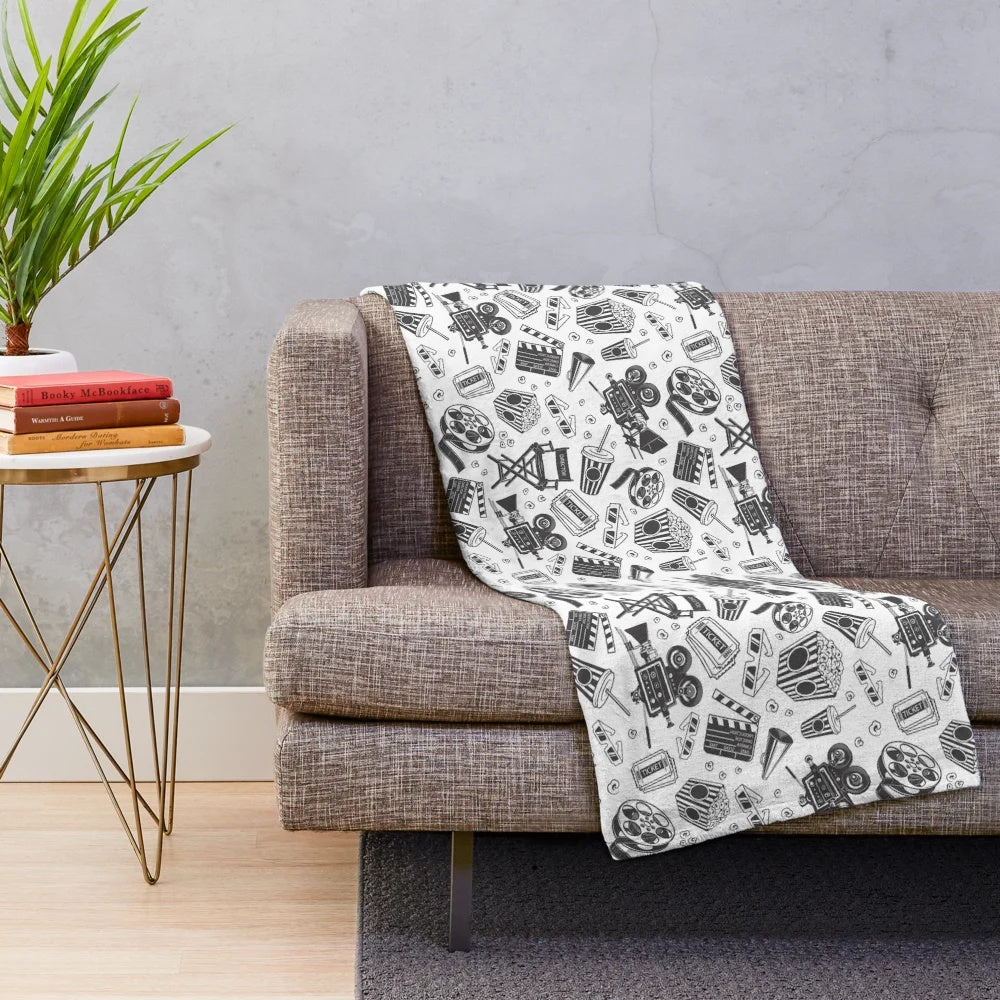 Cinema-themed plush blanket with seamless pattern including movie elements