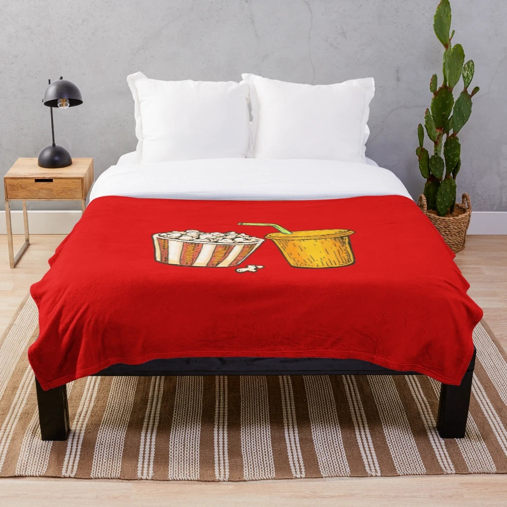 Plush blanket featuring an illustration of cinema popcorn and soda