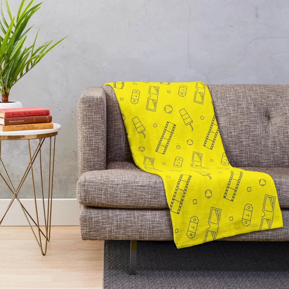 A plush, cozy blanket with a film or movie-inspired print design