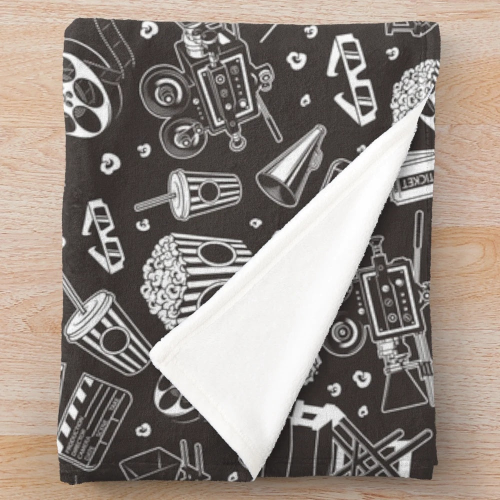 Cinema-themed plush blanket with seamless repeating pattern