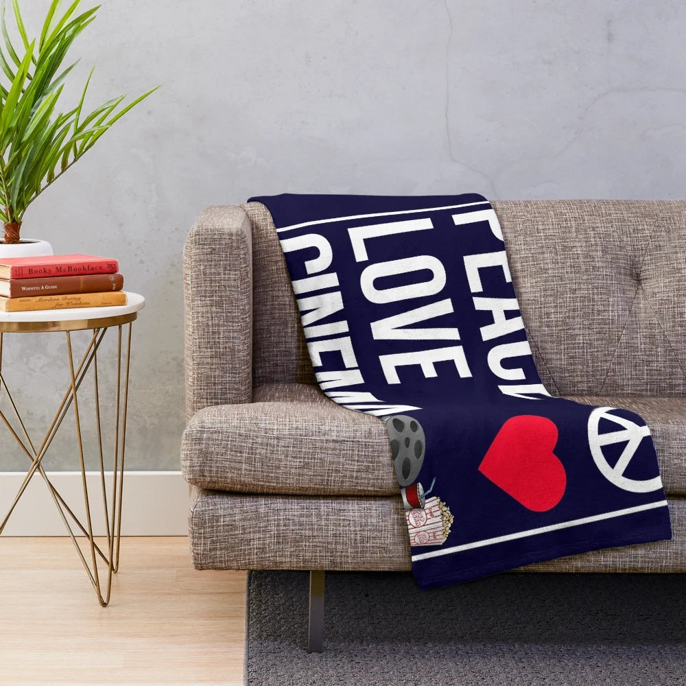 Plush blanket with "Peace Love Cinema" design, perfect for cinema fans