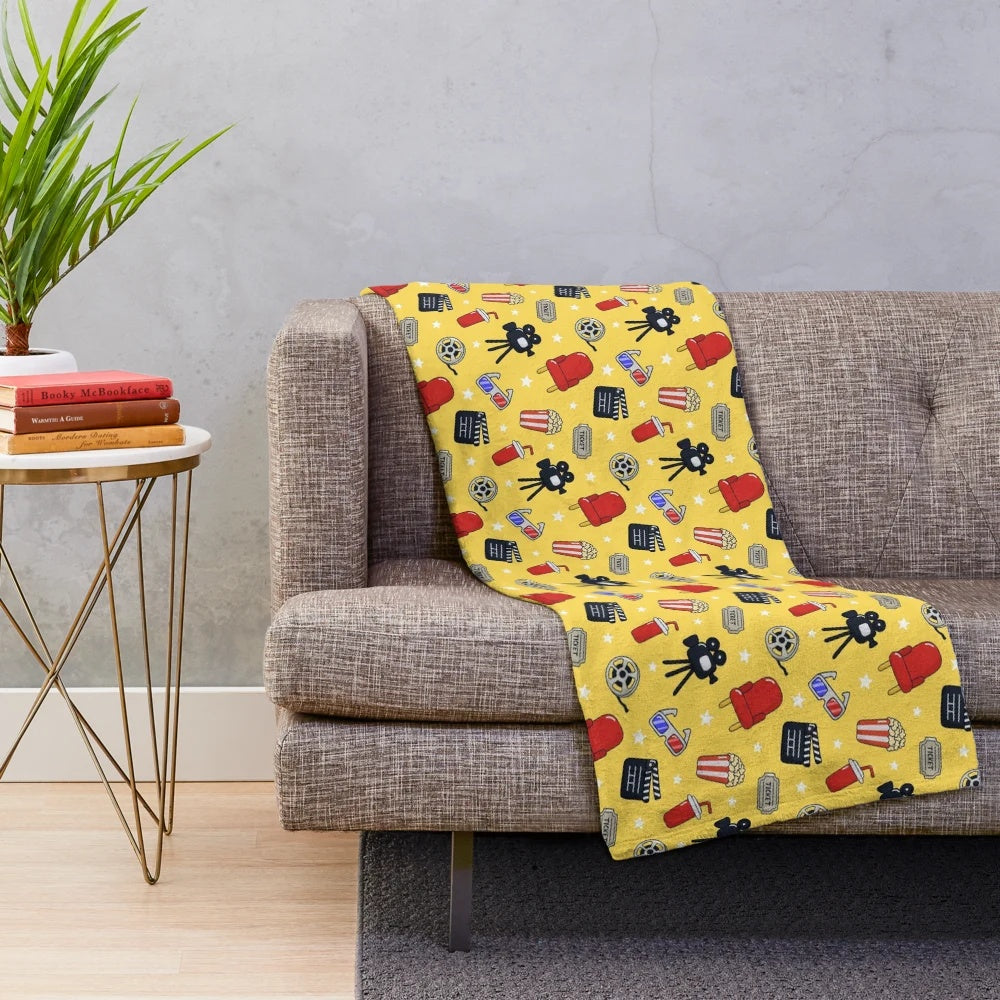 Cinema-themed plush blanket with a whimsical pattern