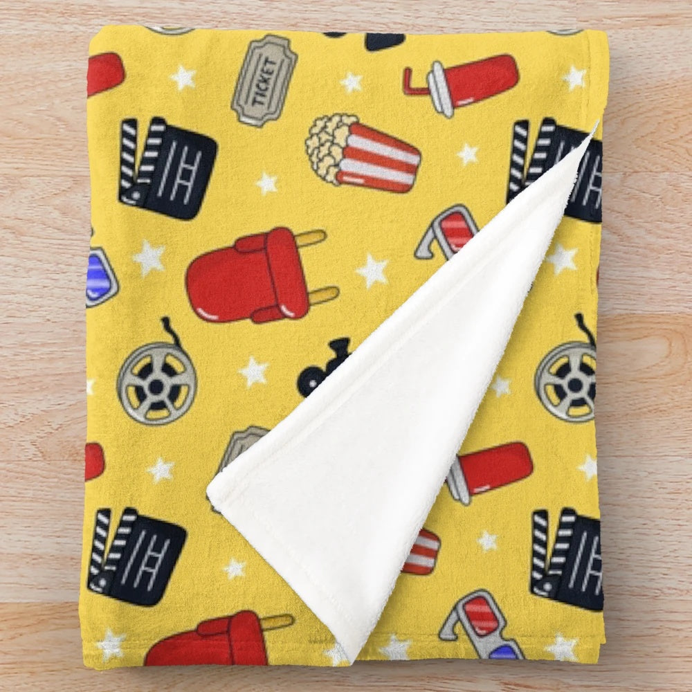 Cinema-themed plush blanket with a whimsical pattern