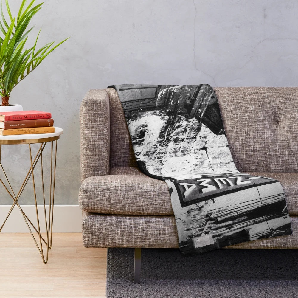 Cozy cinema plush blanket featuring a vintage black and white cityscape with a movie theater