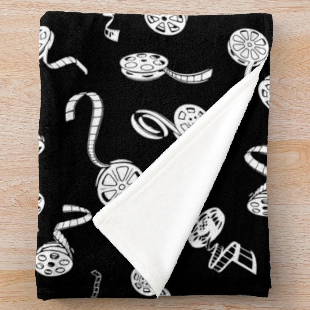 Plush blanket with a cinema-inspired pattern