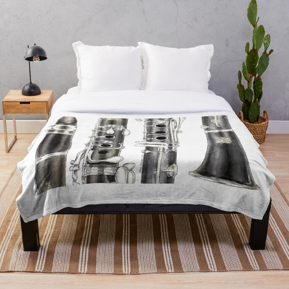 A soft and plush blanket featuring a clarinet design, perfect for music enthusiasts