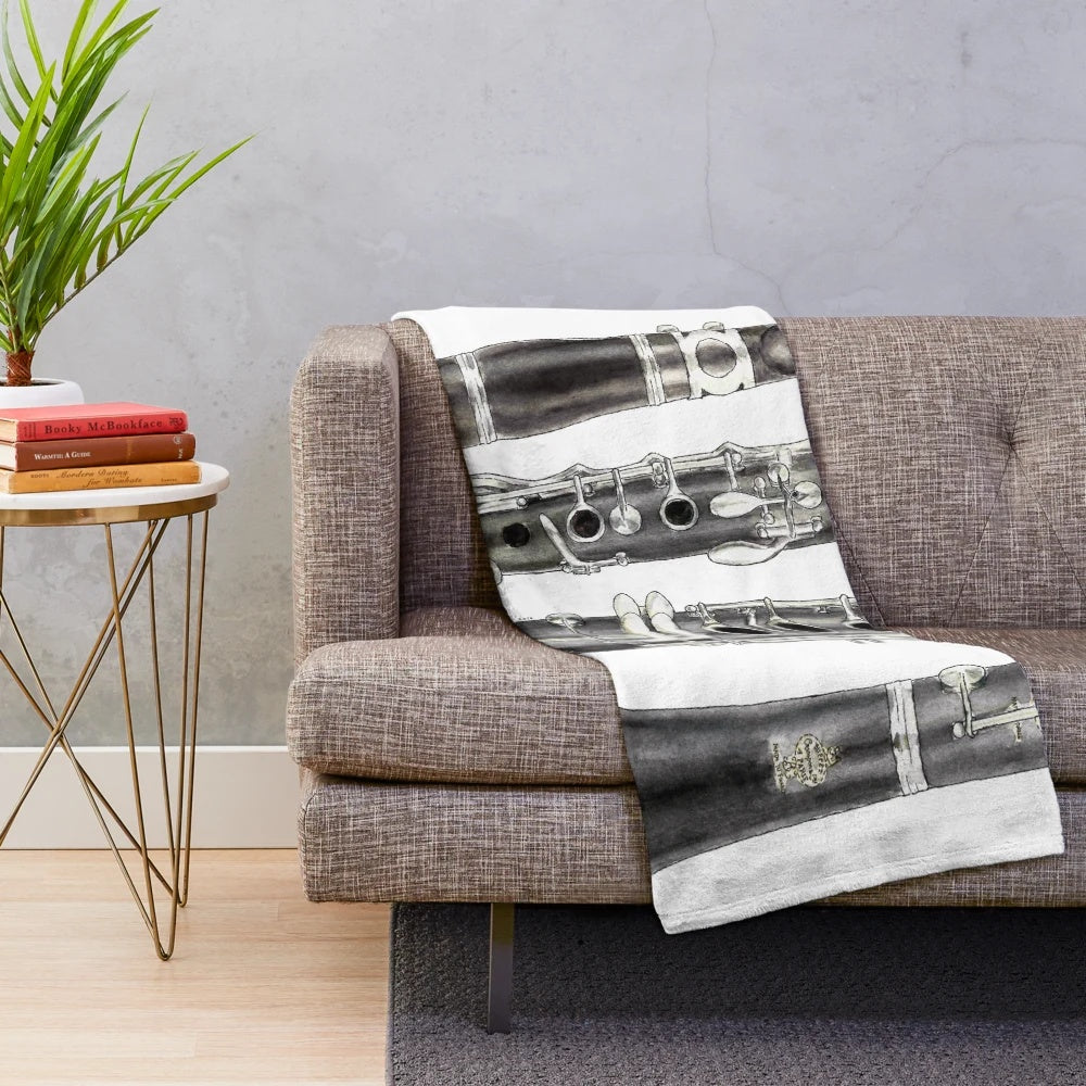 A soft and plush blanket featuring a clarinet design, perfect for music enthusiasts