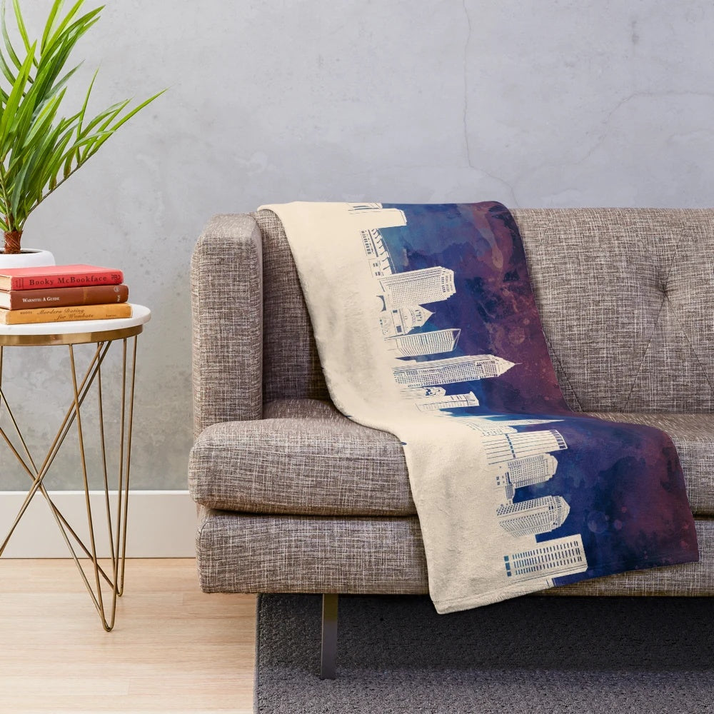 Plush blanket with a minimalist illustration of the Cleveland, Ohio city skyline