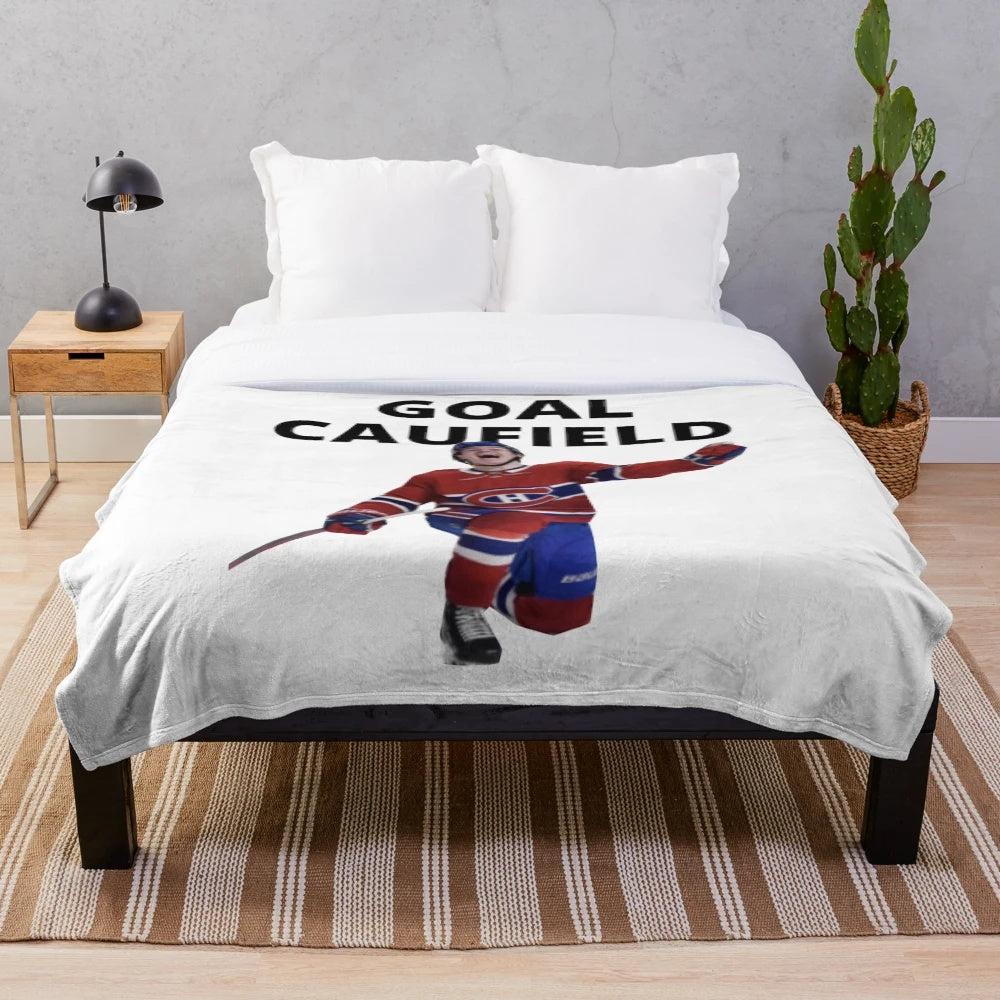 Image of a plush blanket featuring hockey player Cole Caufield