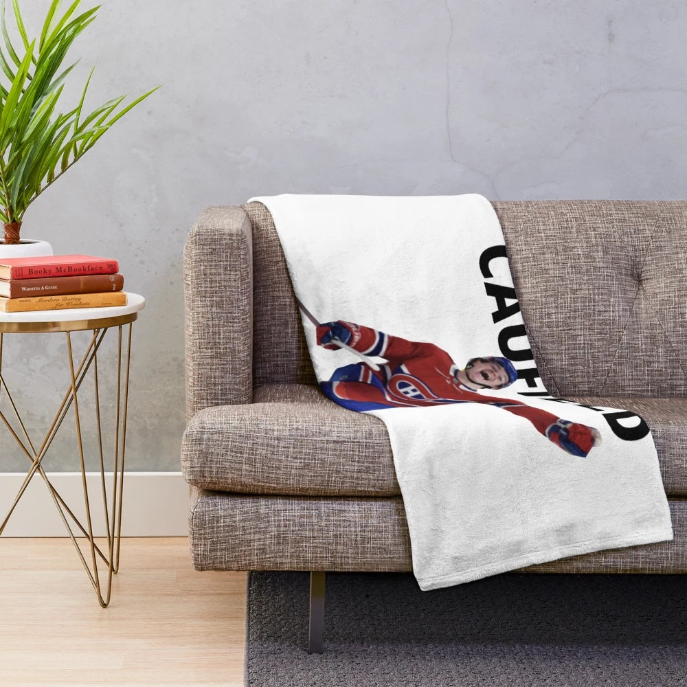 Image of a plush blanket featuring hockey player Cole Caufield