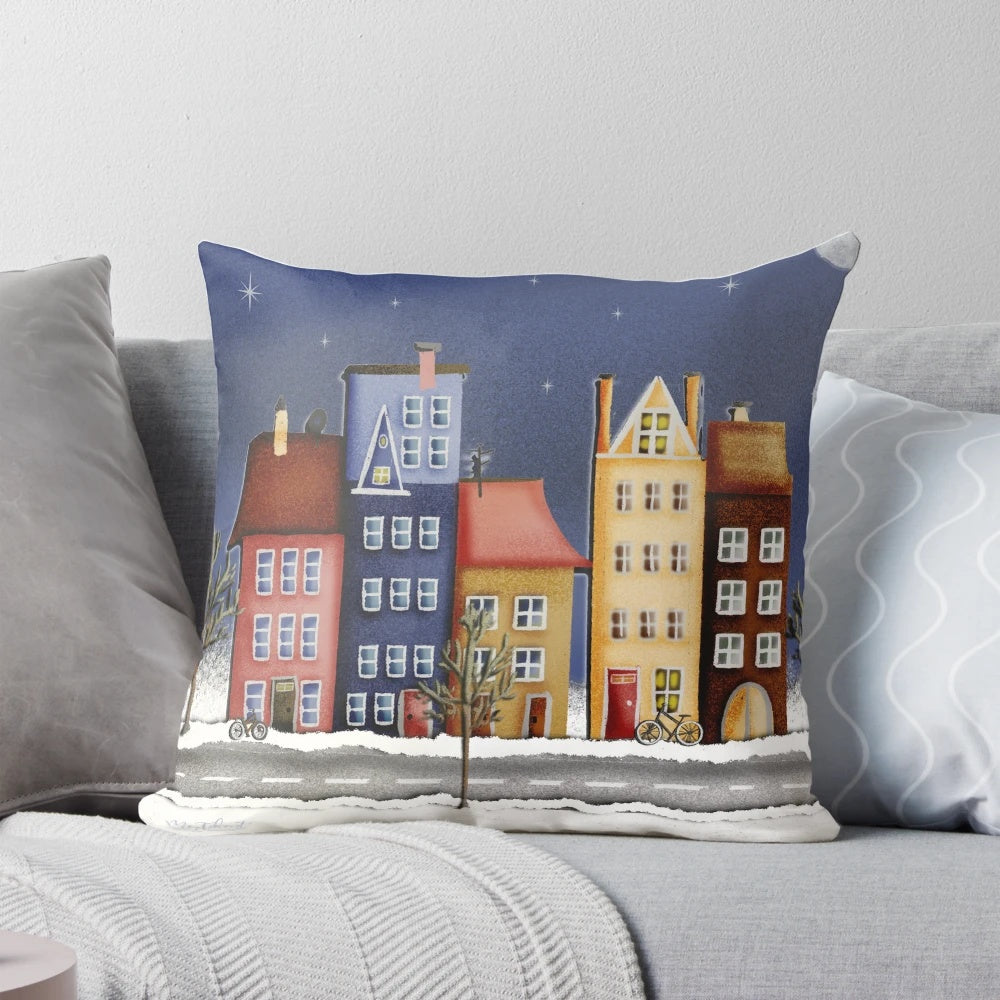 Vibrant pillow with a winter landscape of colorful houses and a starry night sky