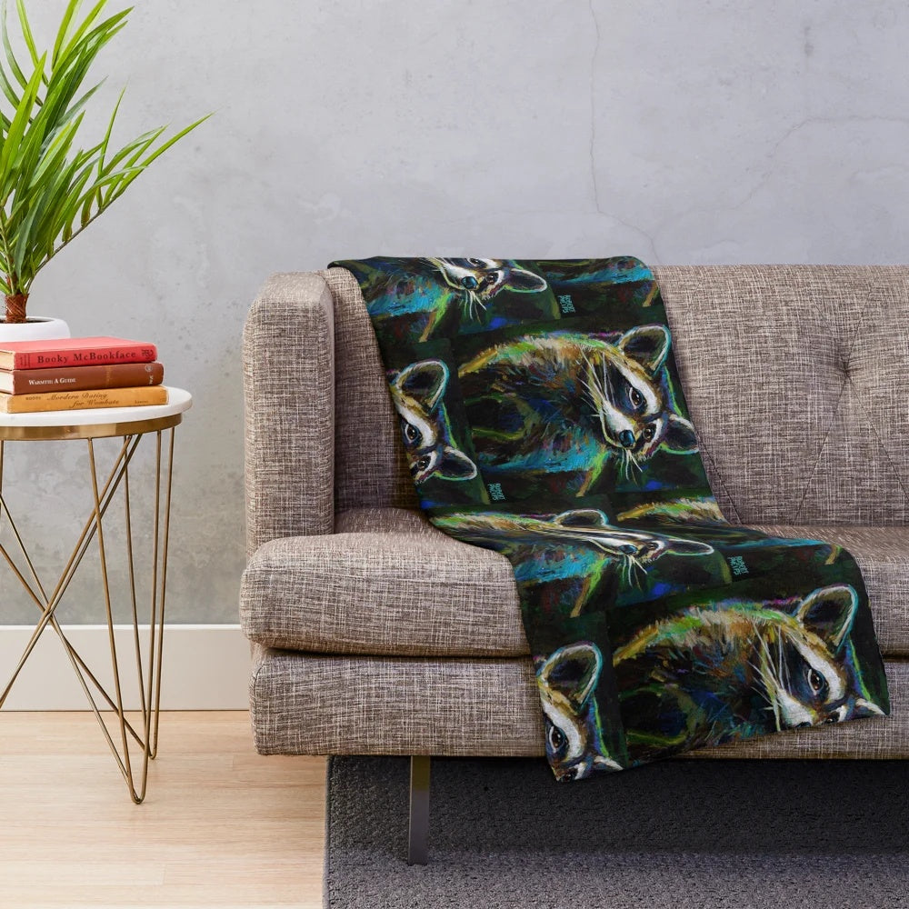 Colorful raccoon painting design on a plush blanket