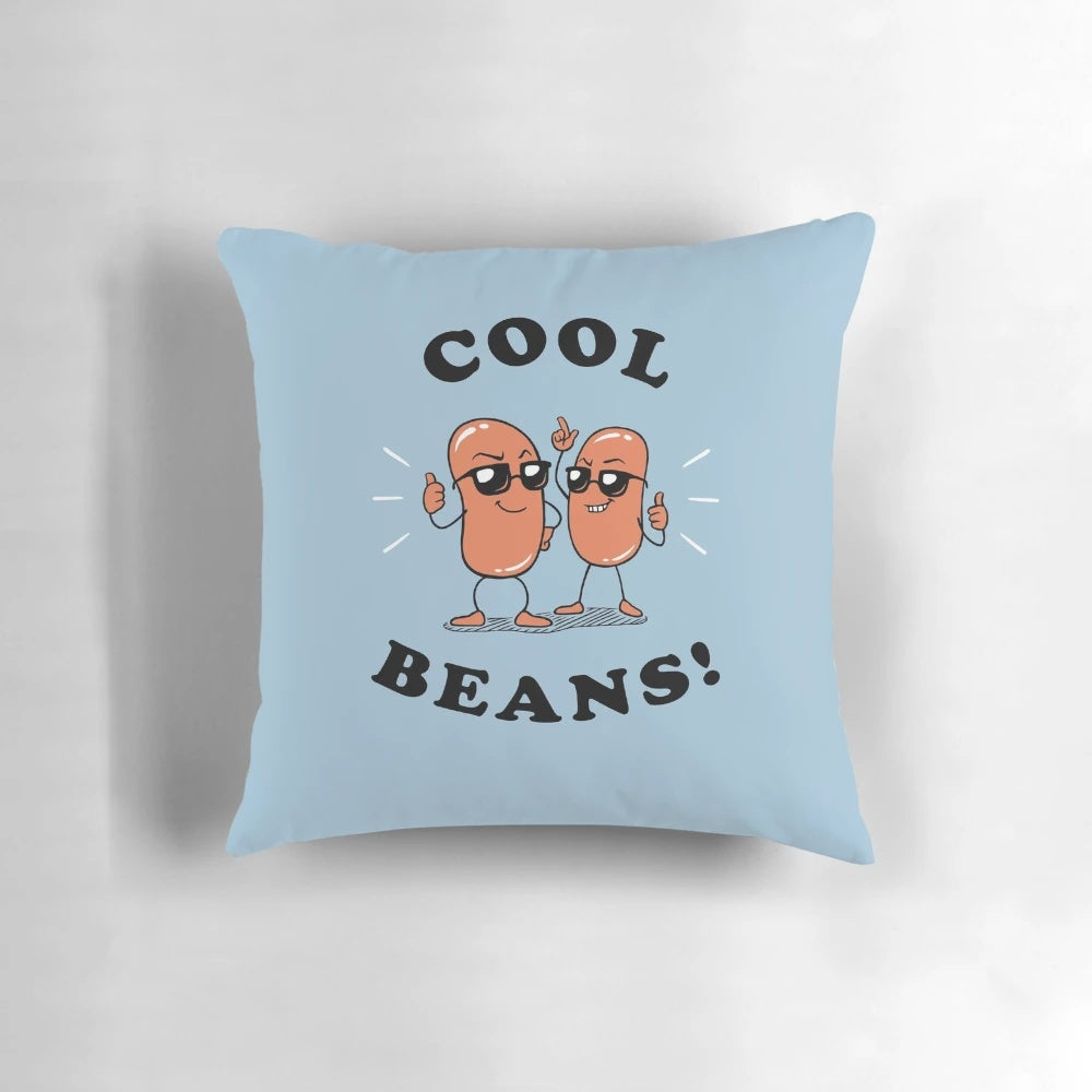 A soft, cozy pillow with the text "Cool Beans" printed on it, perfect for adding a touch of humor to your home decor.