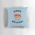 A soft, cozy pillow with the text "Cool Beans" printed on it, perfect for adding a touch of humor to your home decor.