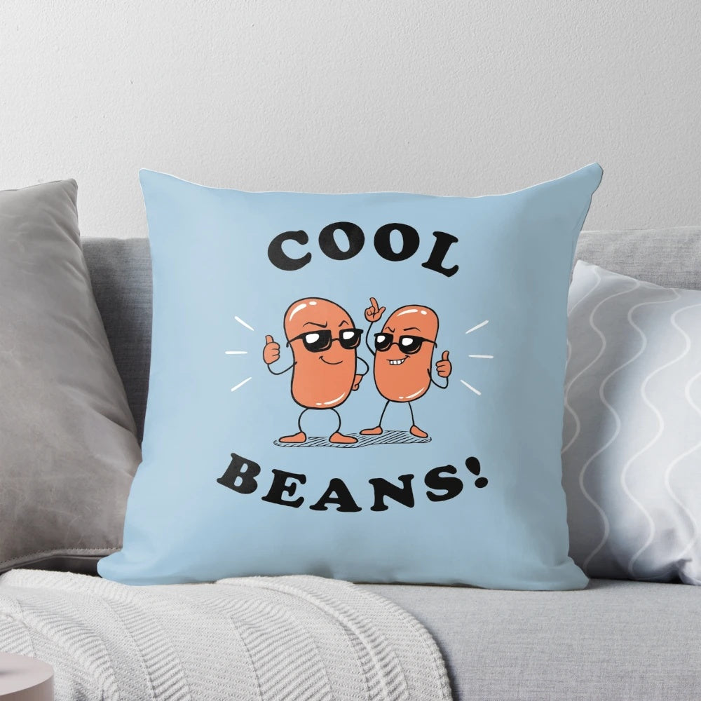 A soft, cozy pillow with the text "Cool Beans" printed on it, perfect for adding a touch of humor to your home decor.