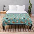 Corgi pattern plush blanket with blue background and dog paw and bone designs