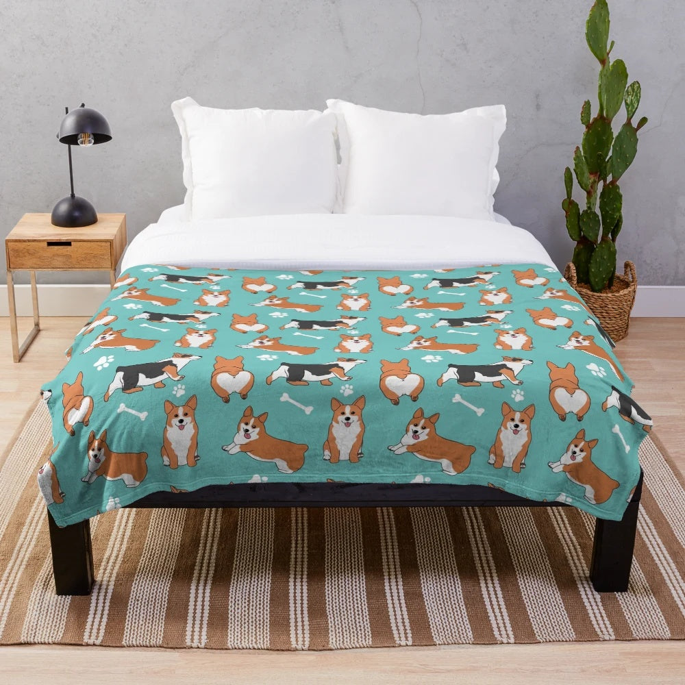 Corgi pattern plush blanket with blue background and dog paw and bone designs