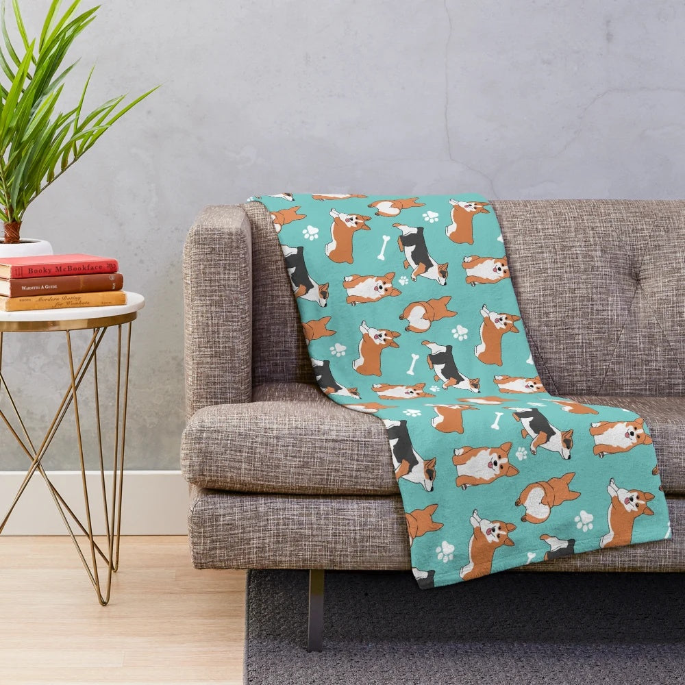 Corgi pattern plush blanket with blue background and dog paw and bone designs