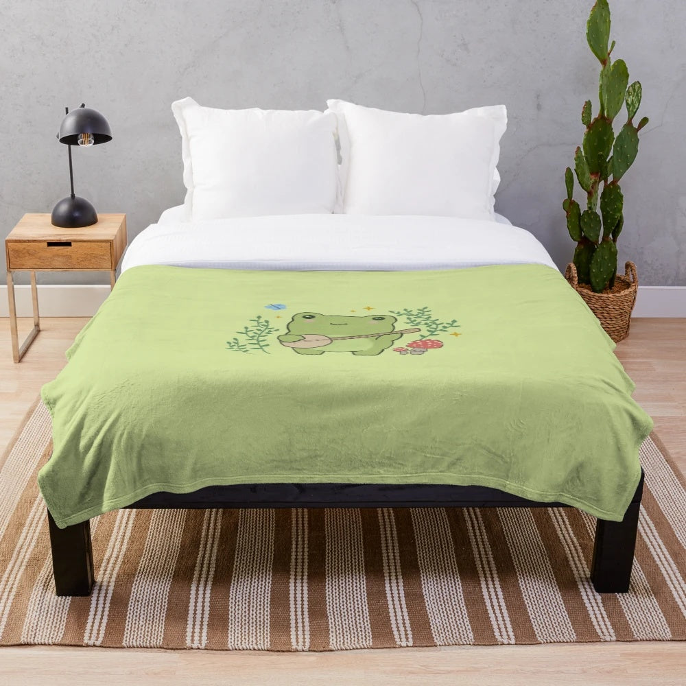 Plush blanket featuring a cute frog playing a banjo with mushrooms and blue butterflies in a cottagecore style