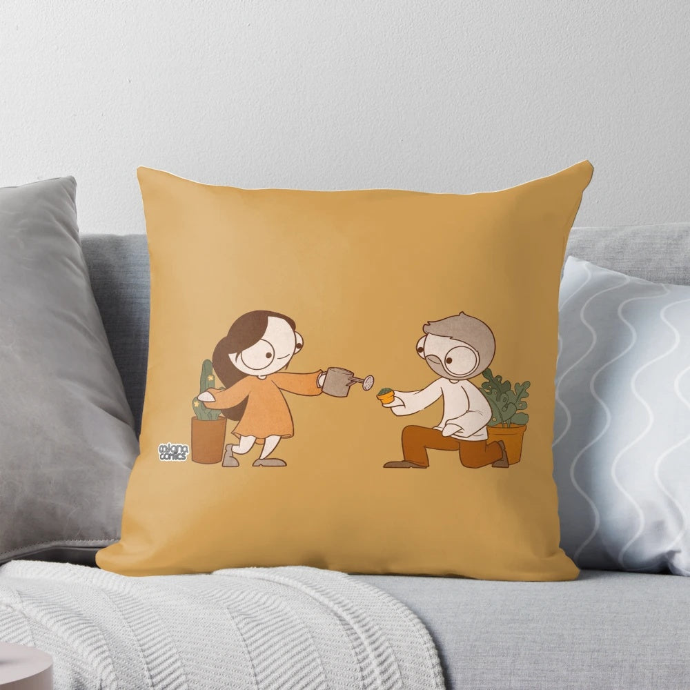 A decorative pillow featuring the popular couple John and Catana from the comics, surrounded by lush, green plants.