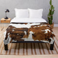 Soft and plush cow hide print blanket for cozy farmhouse decor