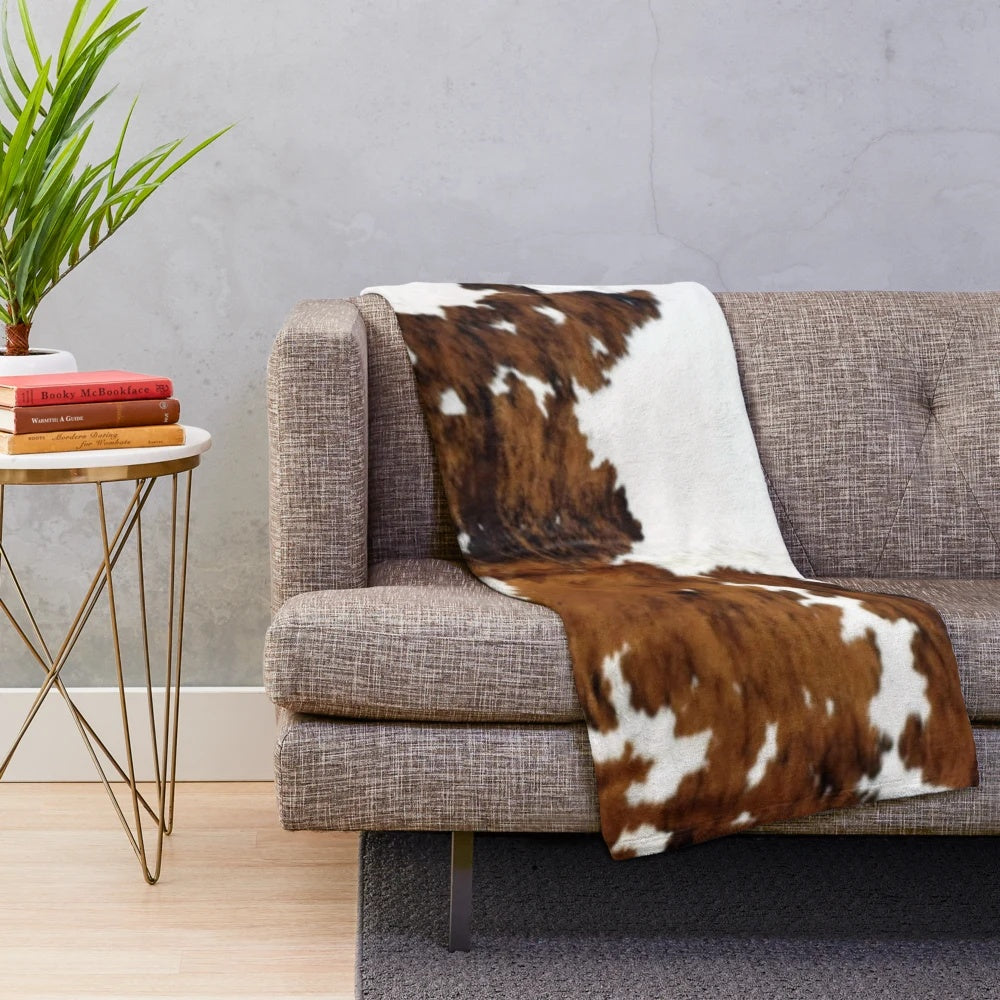 Soft and plush cow hide print blanket for cozy farmhouse decor