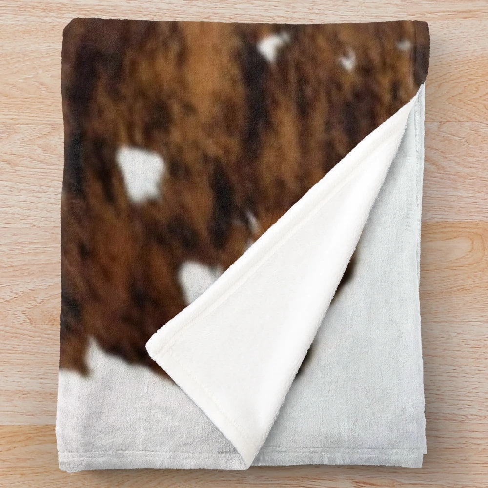 Soft and plush cow hide print blanket for cozy farmhouse decor