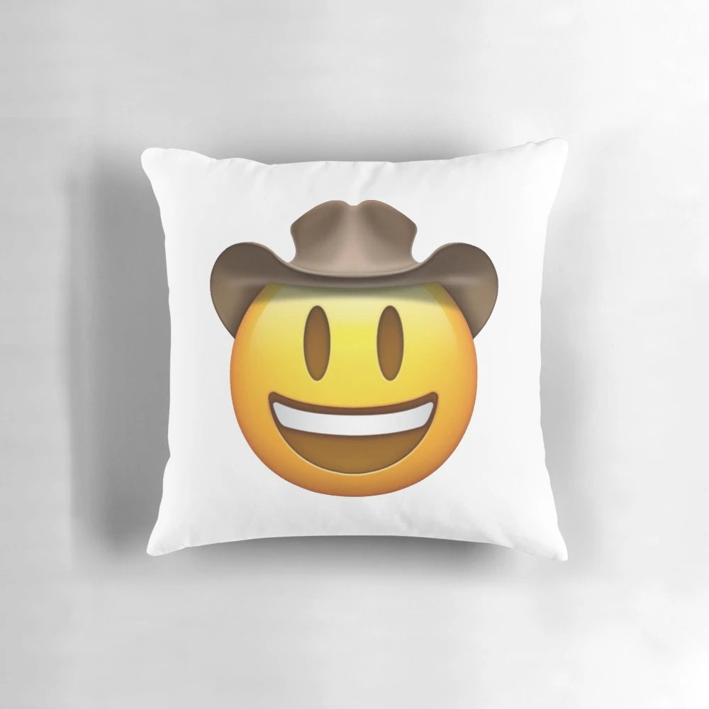 Decorative throw pillow featuring a smiley face emoji design in a cowboy hat
