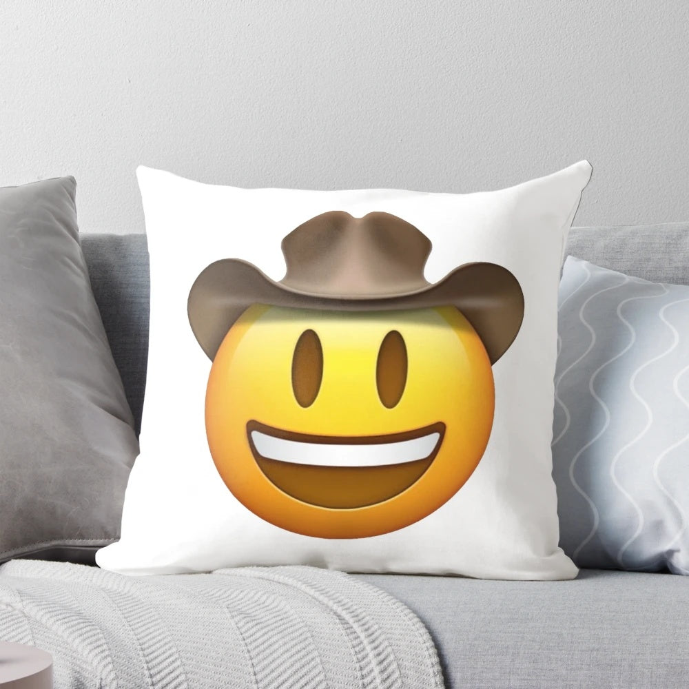 Decorative throw pillow featuring a smiley face emoji design in a cowboy hat