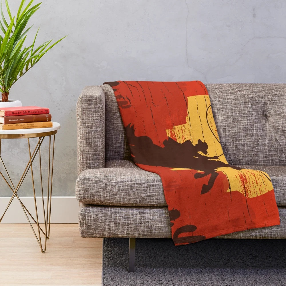 Plush blanket featuring a cowboy silhouette against a sunset landscape