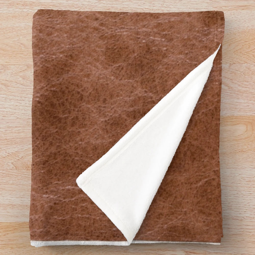 Cowhide-inspired plush blanket with a soft, warm, and comfortable texture