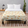 Cream plush blanket with cute cartoon-style illustration of Nova Scotia Duck Tolling Retrievers and mallard ducklings