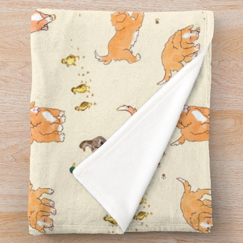 Cream plush blanket with cute cartoon-style illustration of Nova Scotia Duck Tolling Retrievers and mallard ducklings