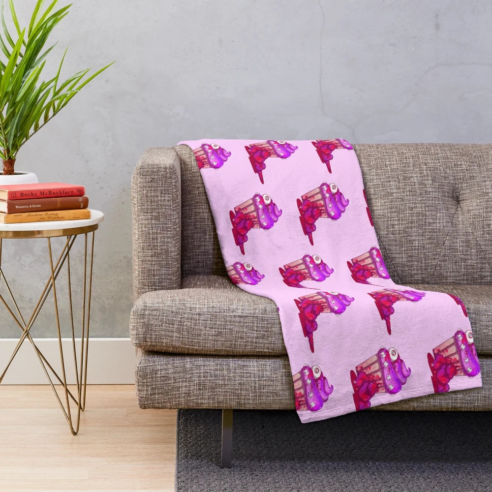 A sweet and spooky pastel goth plush blanket featuring creepy cute designs
